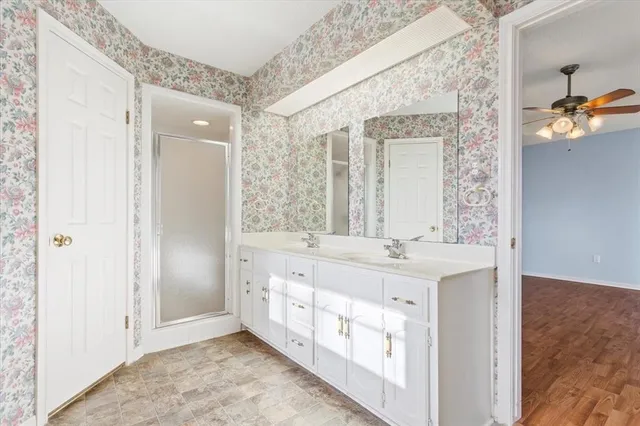 a bathroom with a double vanity sink and mirror