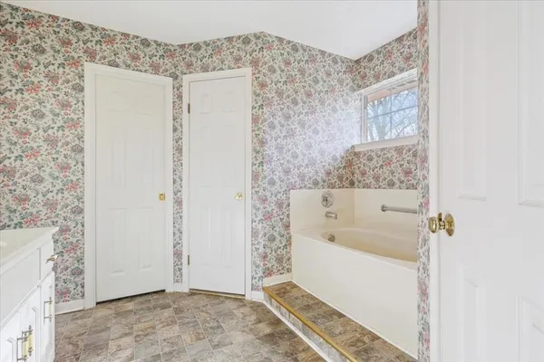a bathroom with a bathtub and a shower