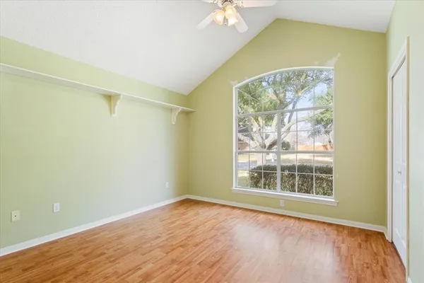 an empty room with wooden floor and a window
