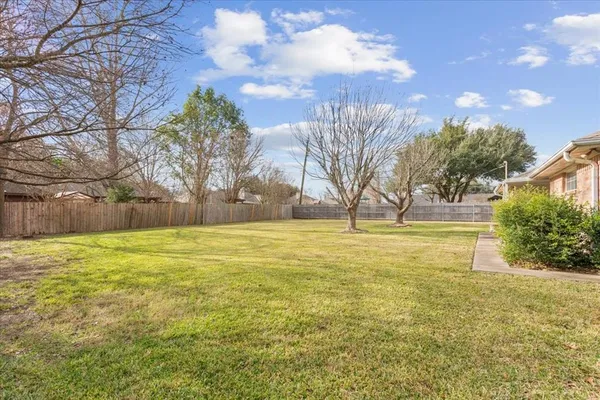 a view of yard with swimming pool and green space