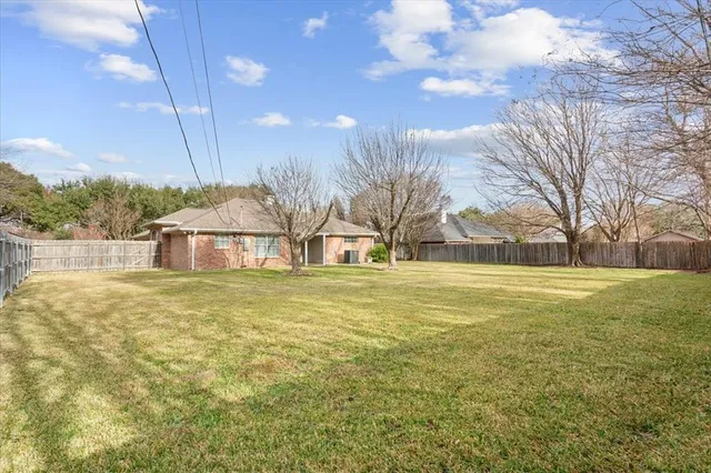 a tall yellow building in middle of the middle of a field
