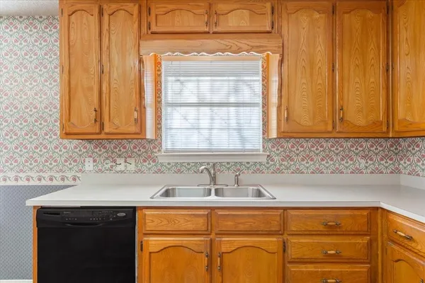 a sink with a granite countertop window