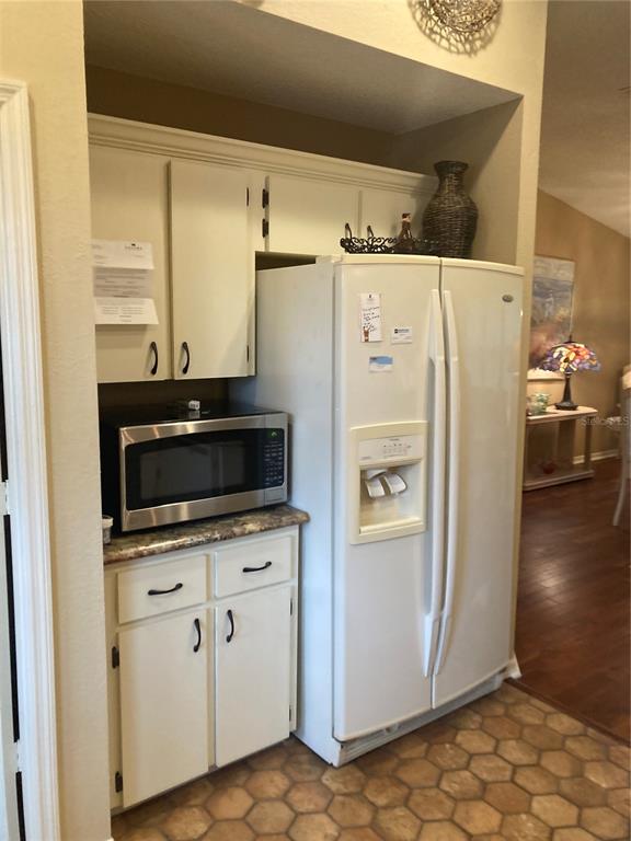 8744 Southwest 108th Ln Road Ocala, FL 34481 - Photo 14 of 28 a white refrigerator freezer sitting in a kitchen