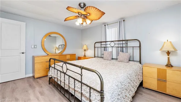a bedroom with bed and a chandelier