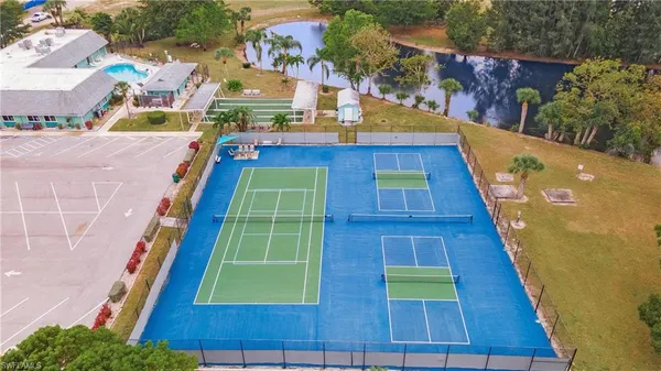 an aerial view of a house with a yard and lake view