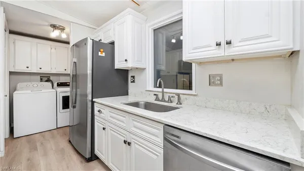 a kitchen with a sink cabinets and wooden floor