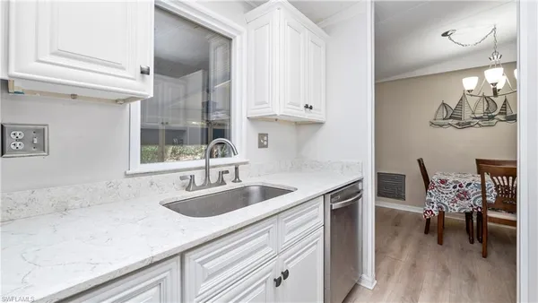 a kitchen with a sink cabinets and window