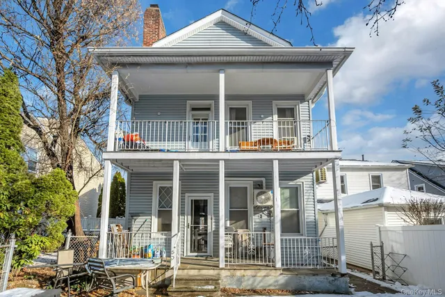 front view of a brick house with a large windows