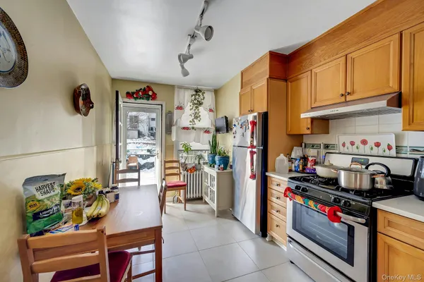 a kitchen with lots of clutter and stainless steel appliances