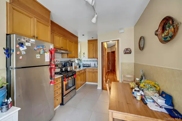 a kitchen with stainless steel appliances granite countertop a refrigerator and a stove