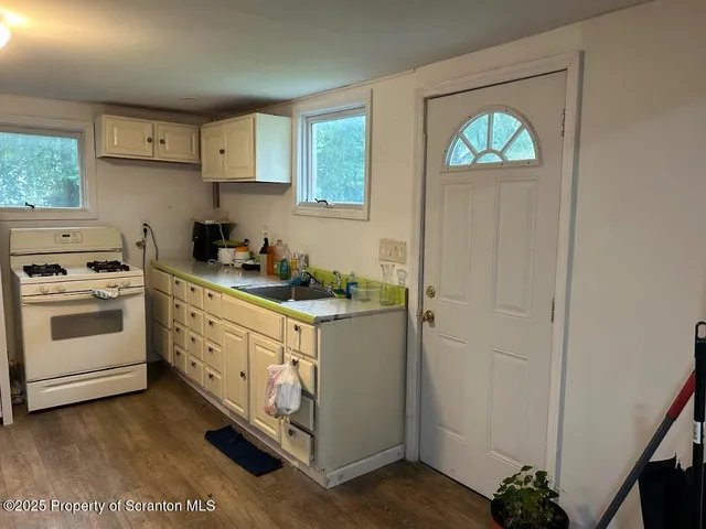 a kitchen with stainless steel appliances white cabinets and a stove