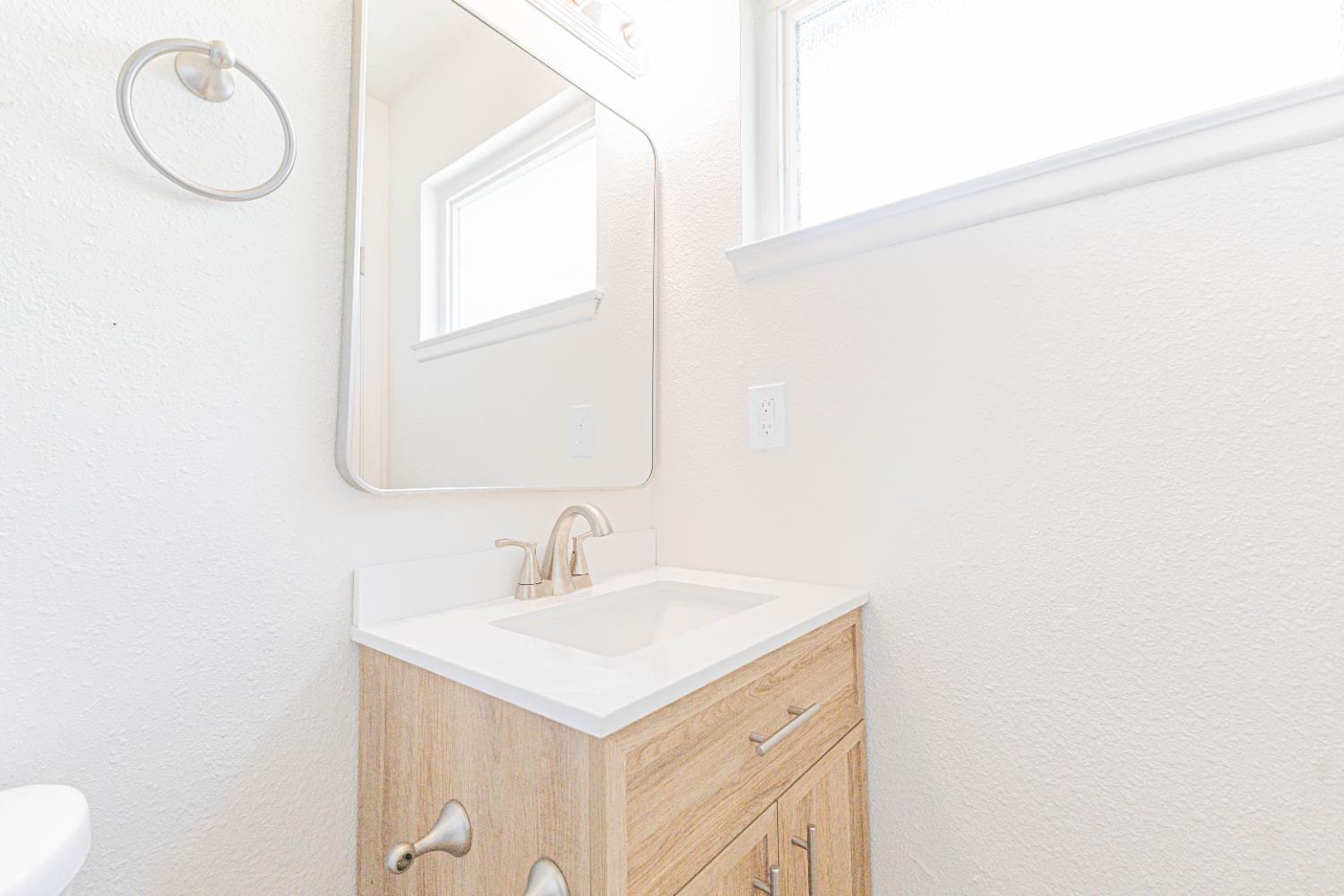 4680 East Grove Avenue Fresno, CA 93725 - Photo 11 of 19 a bathroom with a sink and a mirror