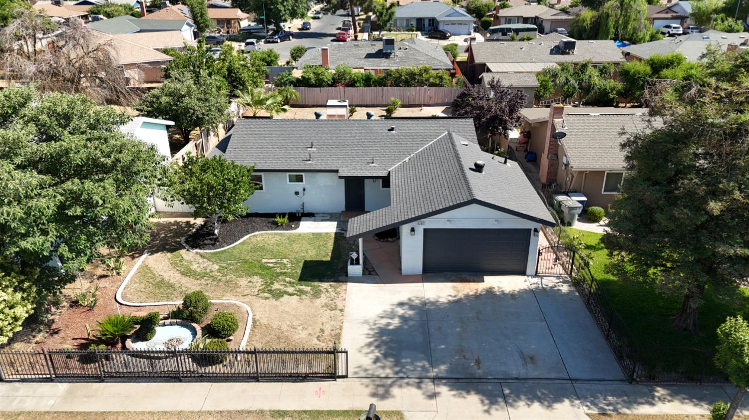 4680 East Grove Avenue Fresno, CA 93725 - Photo 15 of 19 a view of a house with a garden