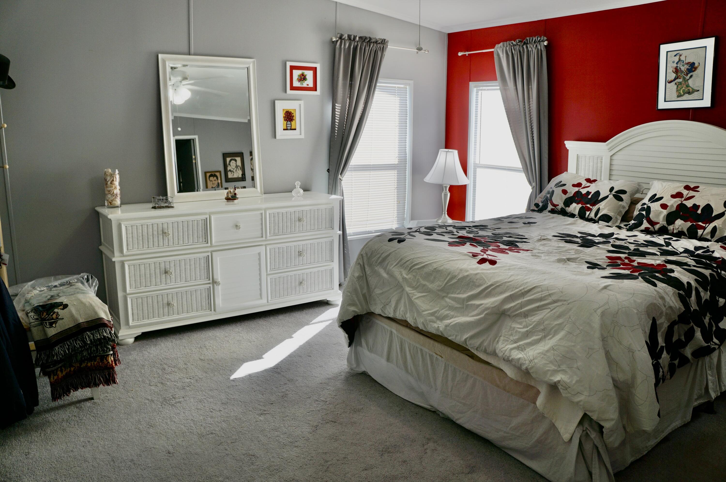 14333 Azucena Court Fort Pierce, FL 34951 - Photo 12 of 28 a bedroom with a bed a couch and dresser