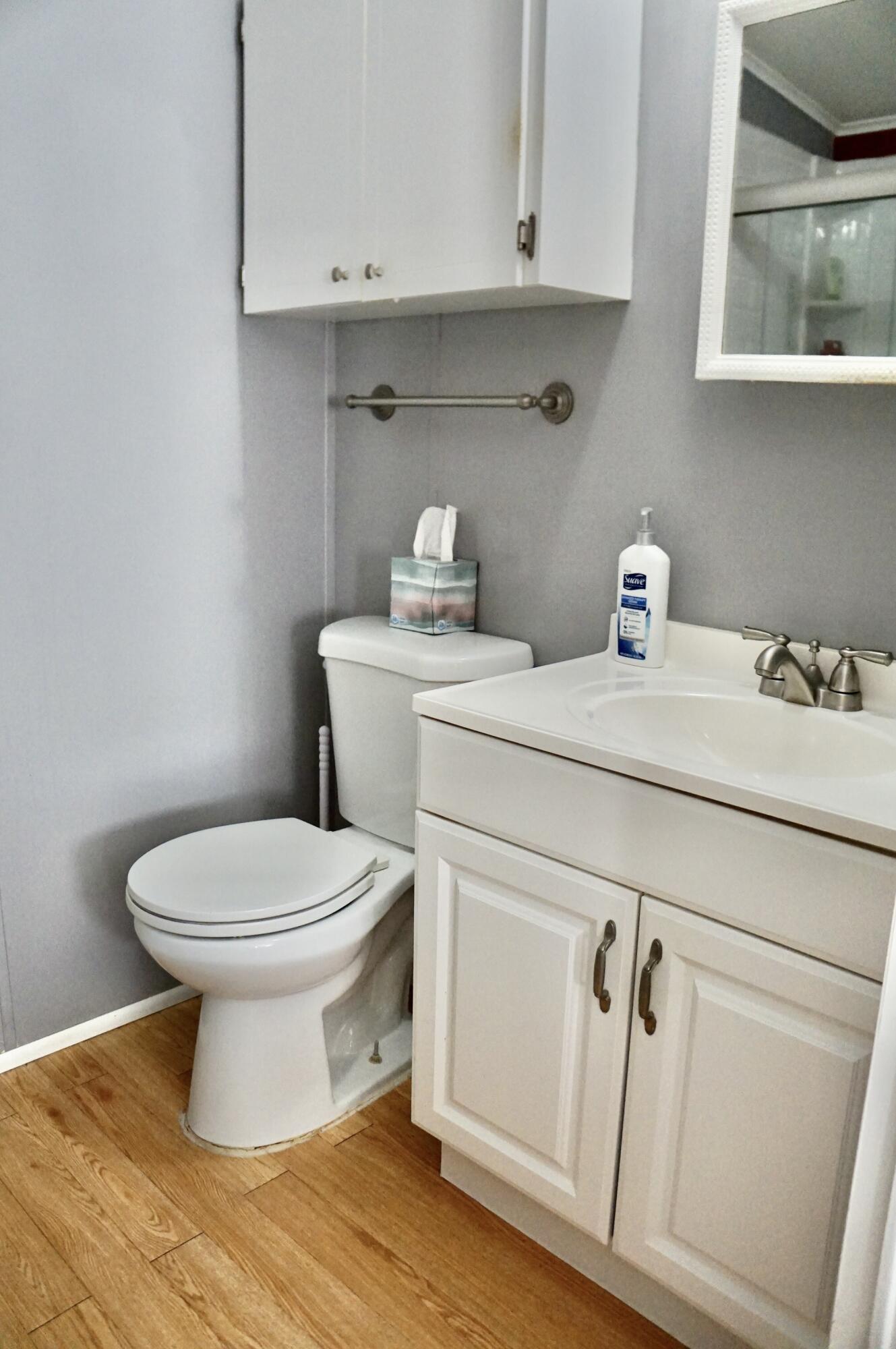 14333 Azucena Court Fort Pierce, FL 34951 - Photo 14 of 28 a bathroom with a toilet sink and vanity