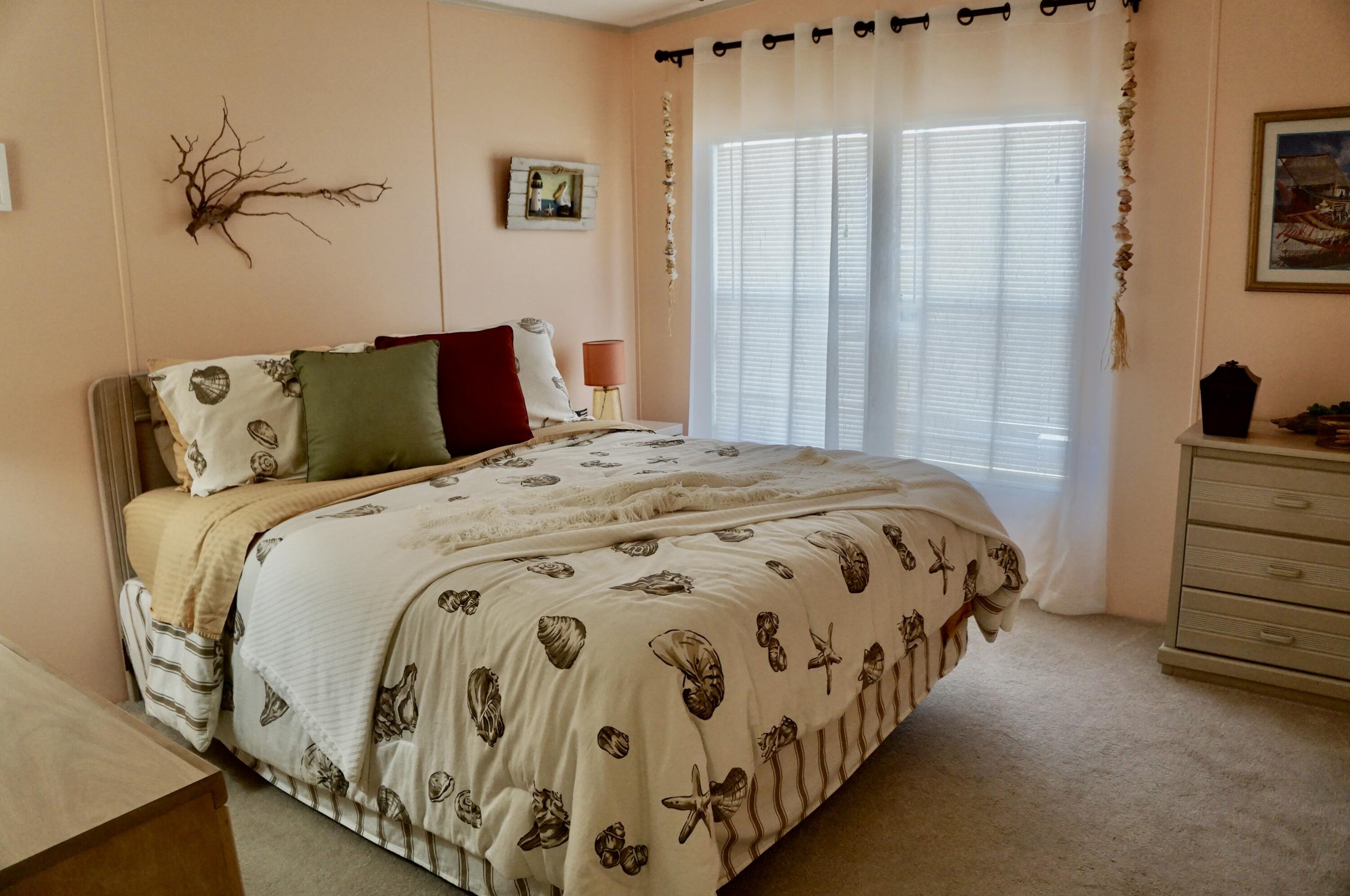 14333 Azucena Court Fort Pierce, FL 34951 - Photo 16 of 28 a bedroom with a bed and a window