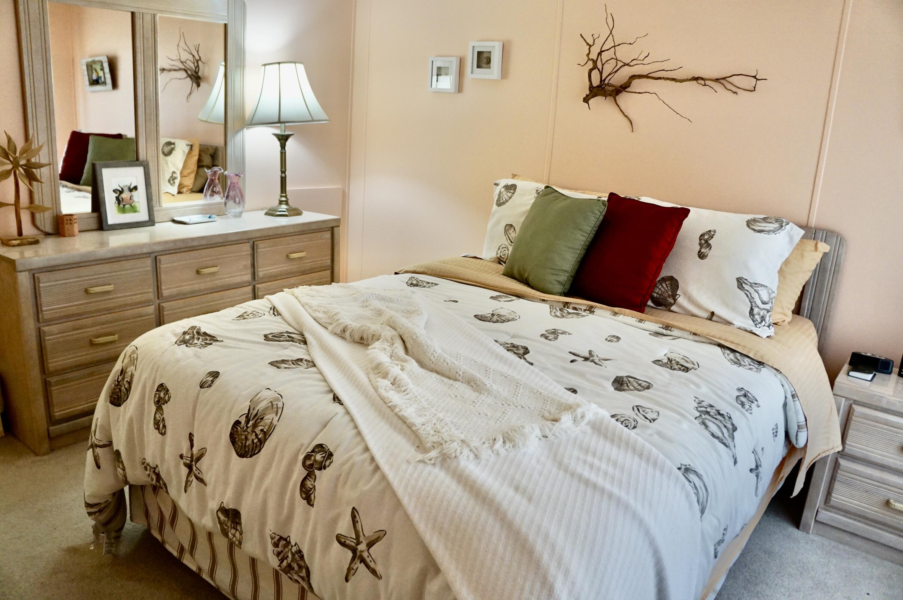 14333 Azucena Court Fort Pierce, FL 34951 - Photo 17 of 28 a bedroom with a bed and a lamp on dresser