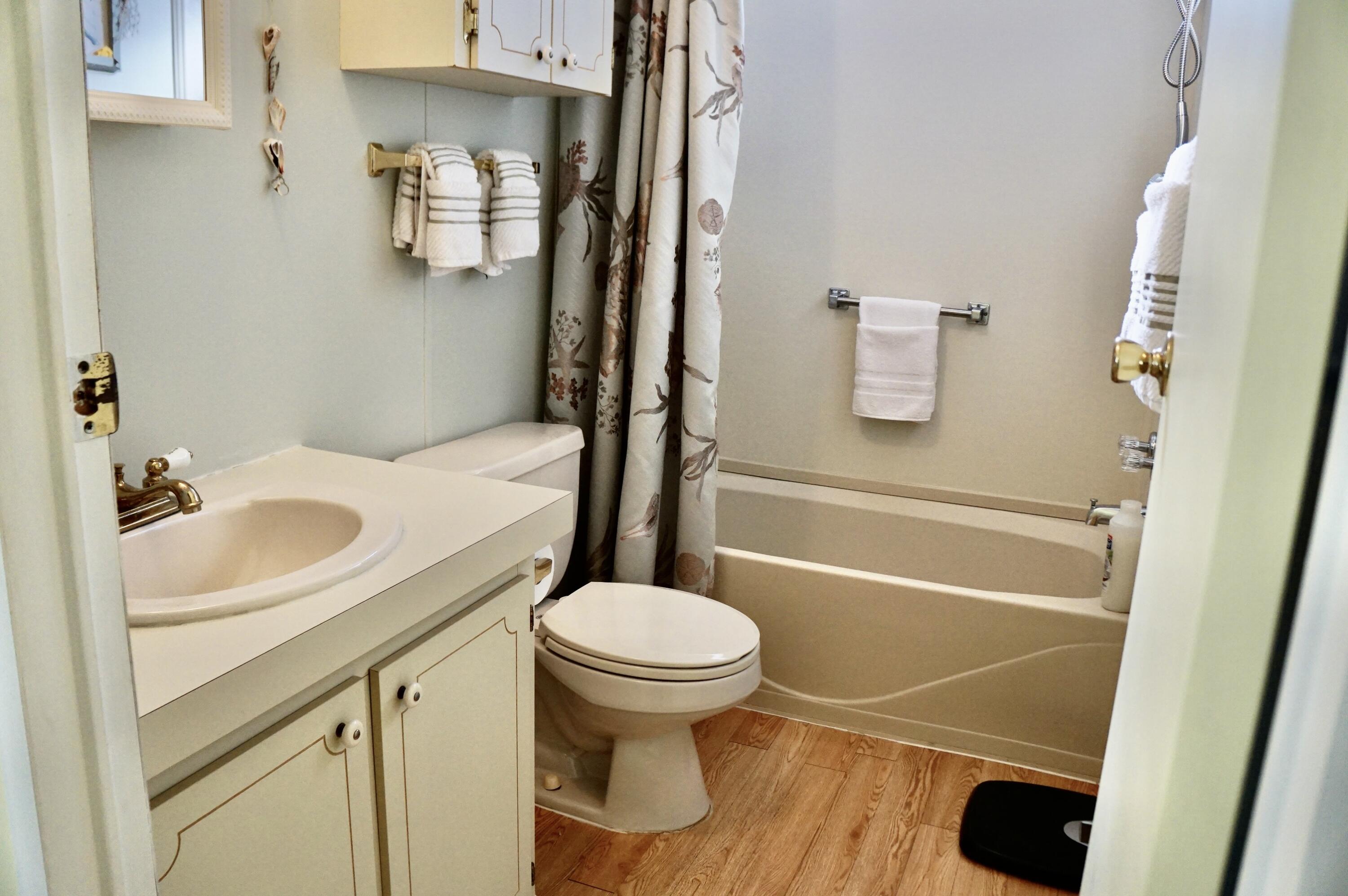 14333 Azucena Court Fort Pierce, FL 34951 - Photo 18 of 28 a bathroom with a sink toilet and shower