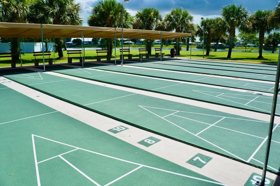 14333 Azucena Court Fort Pierce, FL 34951 - Photo 28 of 28 a view of a tennis ground with large trees