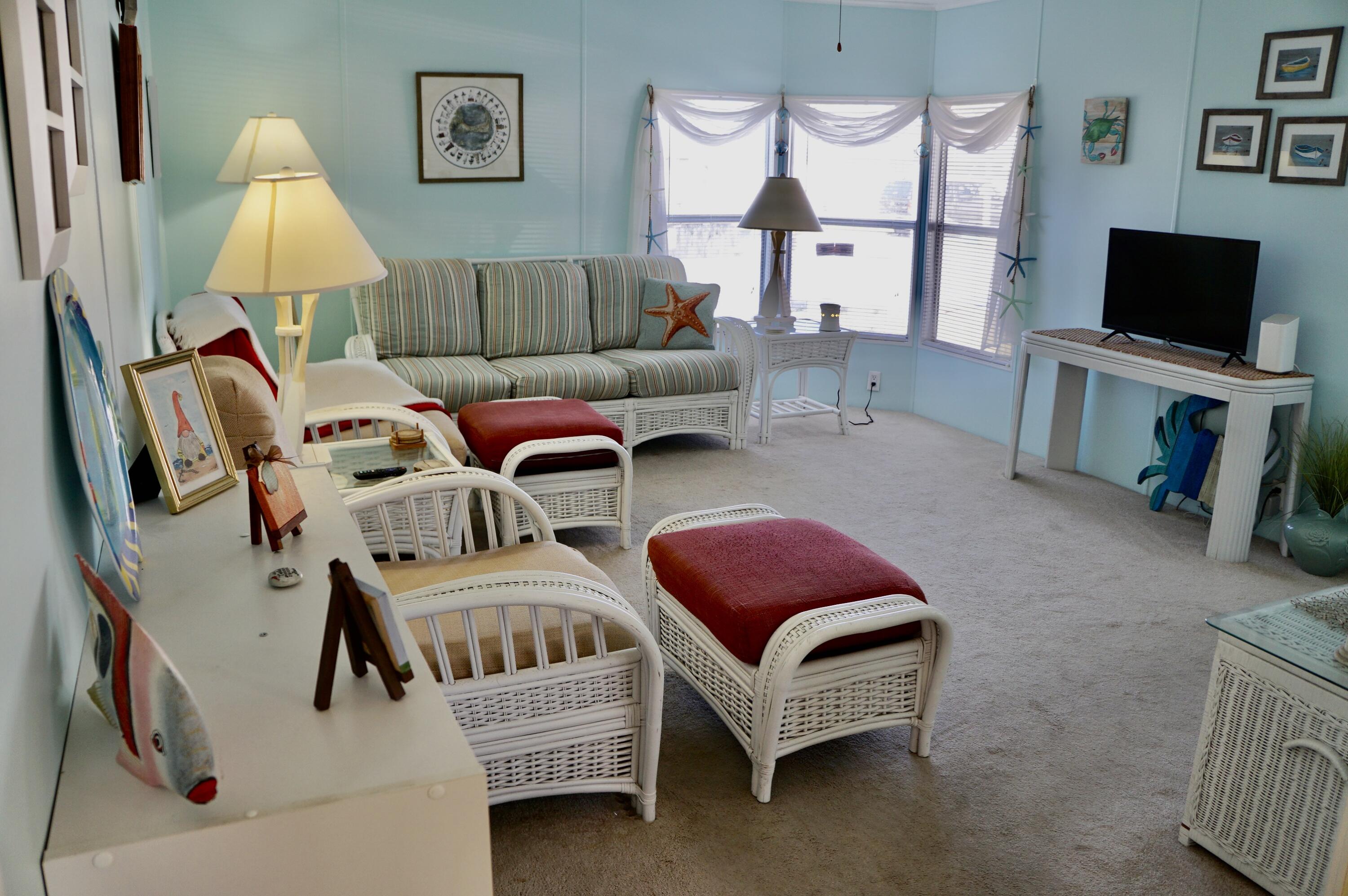 14333 Azucena Court Fort Pierce, FL 34951 - Photo 6 of 28 a living room with furniture and a flat screen tv