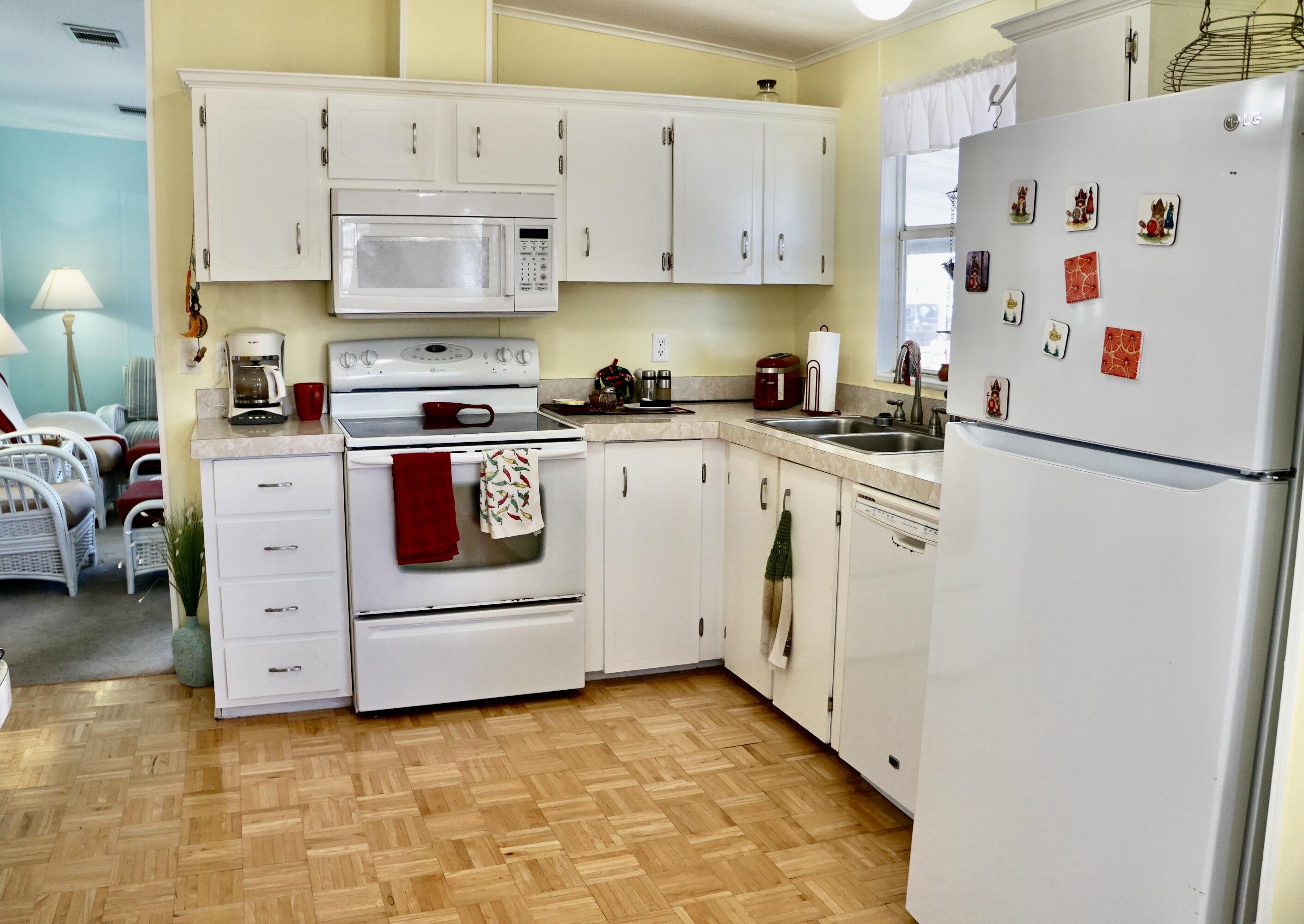 14333 Azucena Court Fort Pierce, FL 34951 - Photo 8 of 28 a kitchen with cabinets appliances and a sink