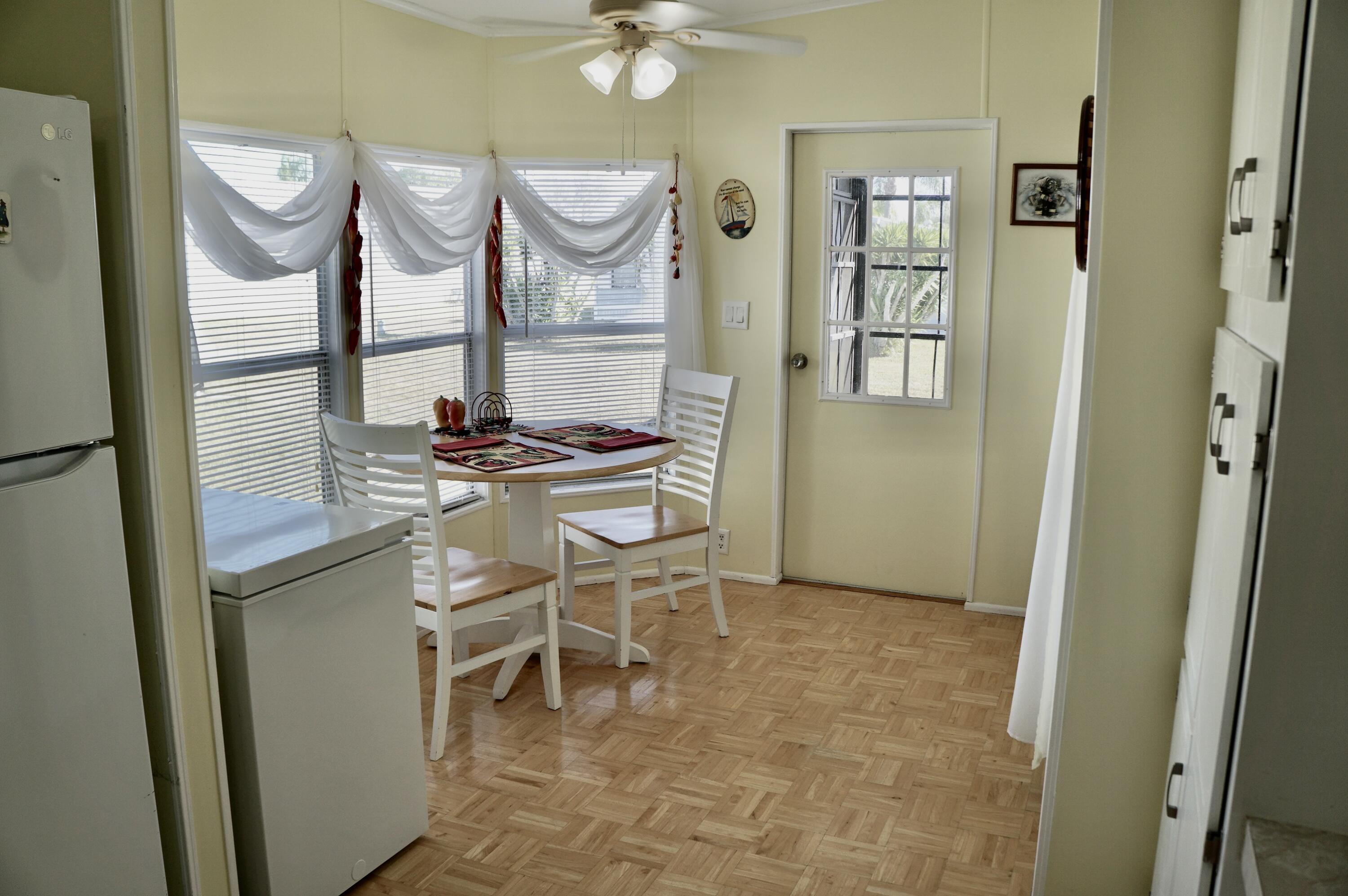 14333 Azucena Court Fort Pierce, FL 34951 - Photo 9 of 28 a kitchen with stainless steel appliances a refrigerator and cabinets