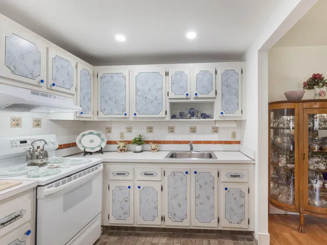 a kitchen with stainless steel appliances granite countertop a sink and cabinets
