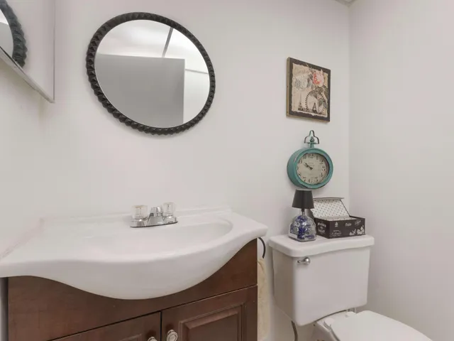 a bathroom with a sink mirror and toilet