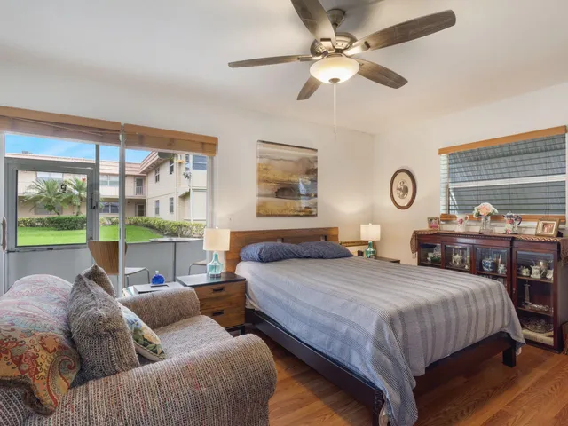 a bedroom with two beds and a large window