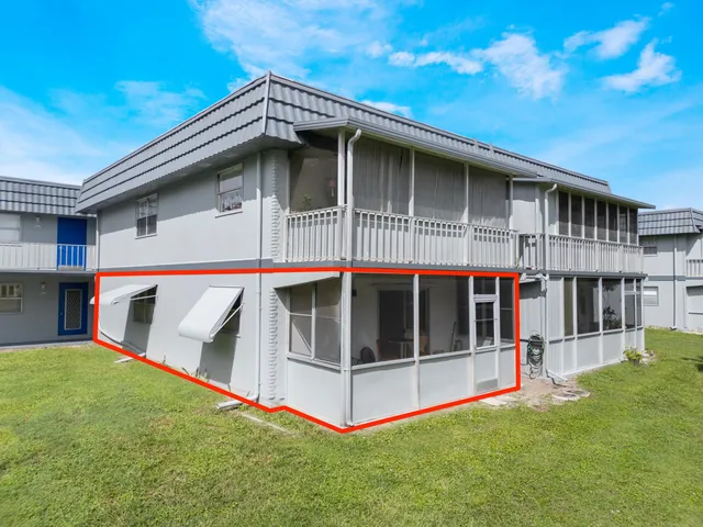 a view of small house with a yard