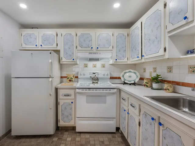 a kitchen with cabinets appliances and a sink