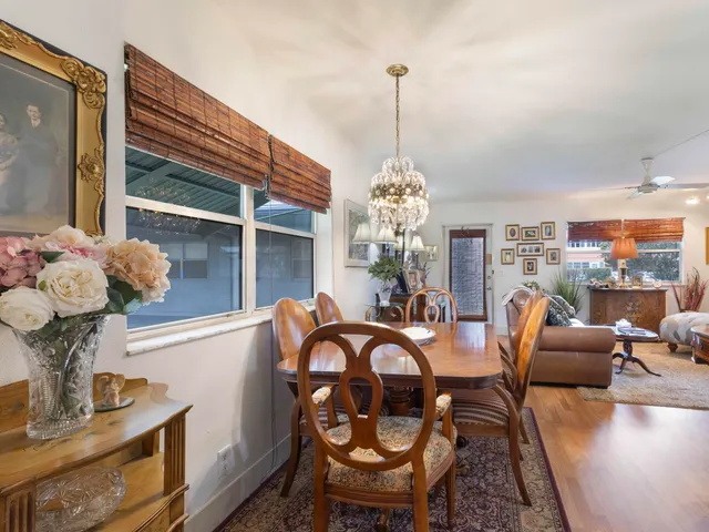 a view of a dining room with furniture wooden floor and chandelier