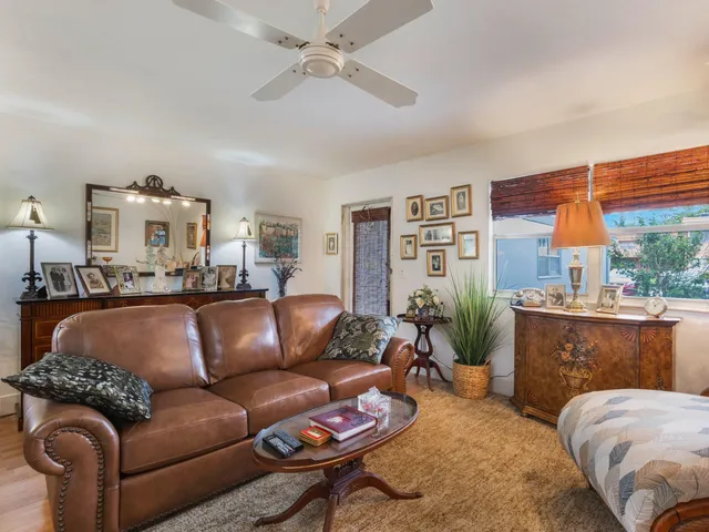 a living room with furniture a chandelier and a window