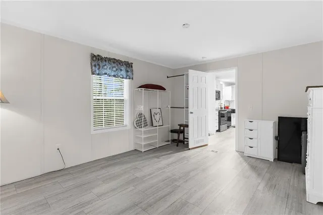 an empty room with furniture and a window