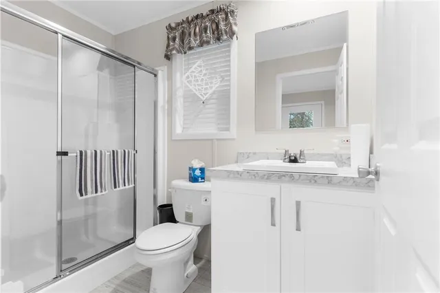 a bathroom with a sink toilet and shower