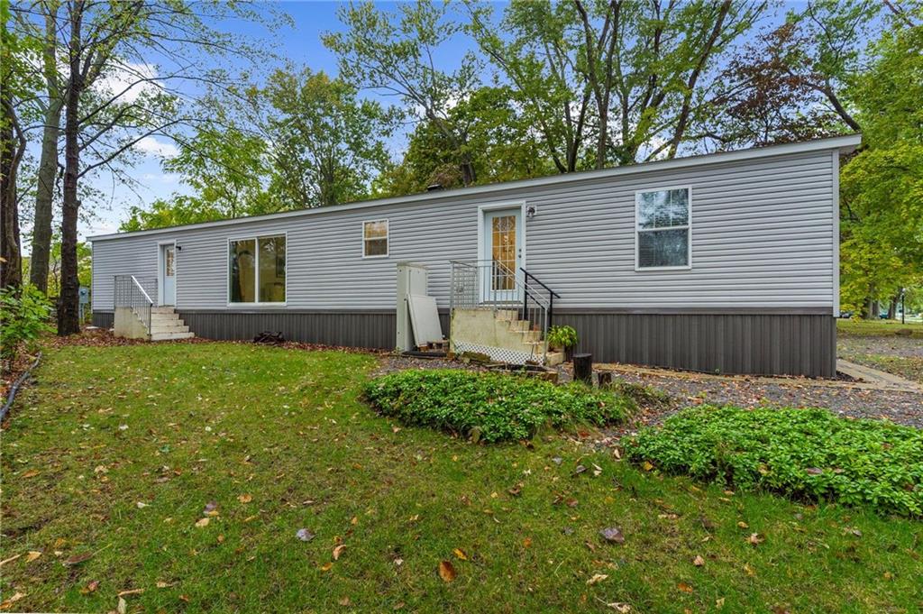 318 Meadowbrook Road Hermitage, PA 16148 - Photo 16 of 18 a backyard of a house with plants and large tree