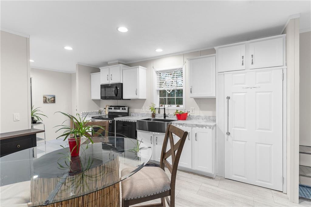 318 Meadowbrook Road Hermitage, PA 16148 - Photo 6 of 18 a living room with furniture a fireplace and a flat screen tv