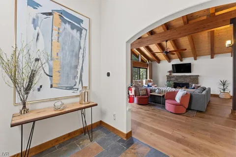 a living room with furniture a flat screen tv and a fireplace