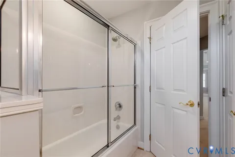a bathroom with a glass shower door