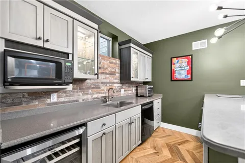 a kitchen with stainless steel appliances a sink microwave and stove