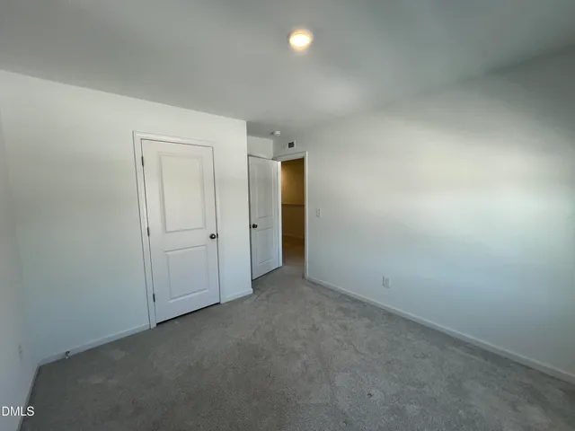 an empty room with closet area
