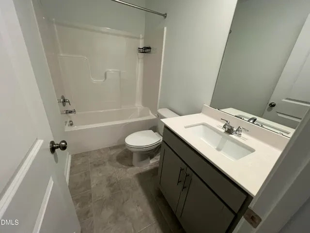 a bathroom with a sink toilet a mirror and shower