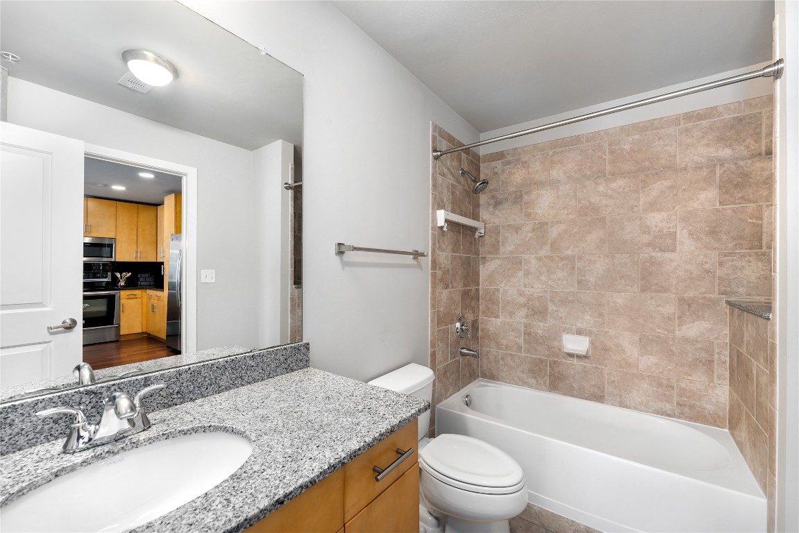 360 Nueces Street, Unit 1805 Austin, TX 78701 - Photo 13 of 28 a bathroom with a granite countertop sink toilet and shower