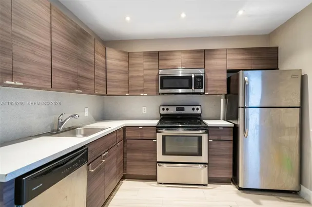 a kitchen with a sink stove and refrigerator