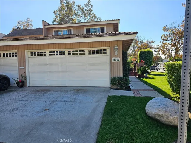 a view of a house with a yard and garage