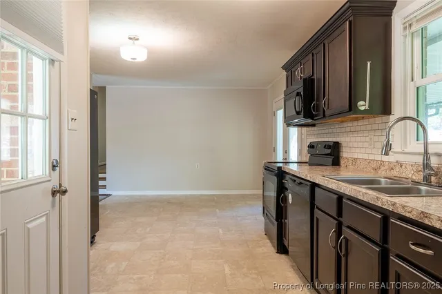 a kitchen with stainless steel appliances granite countertop a sink and a stove