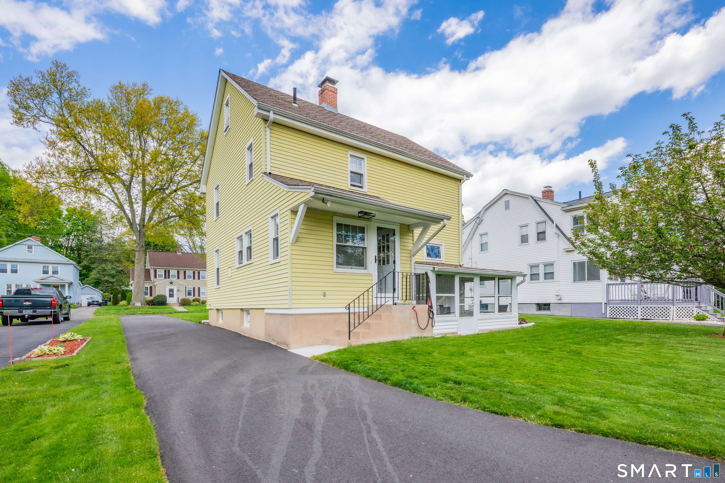 44 Beverly Road Wethersfield, CT 06109 - Photo 5 of 31 a front view of a house with a yard and trees