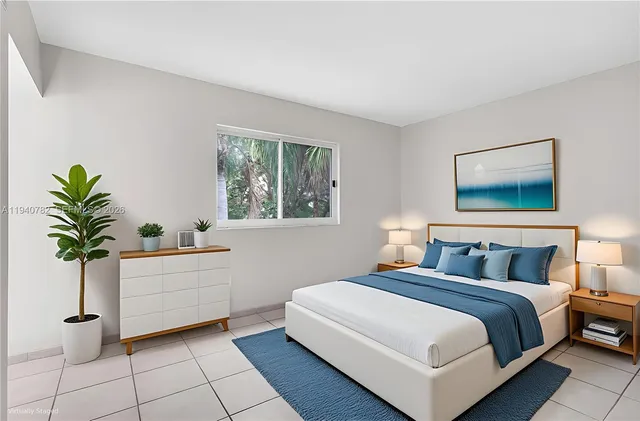 a bedroom with a large bed and a window