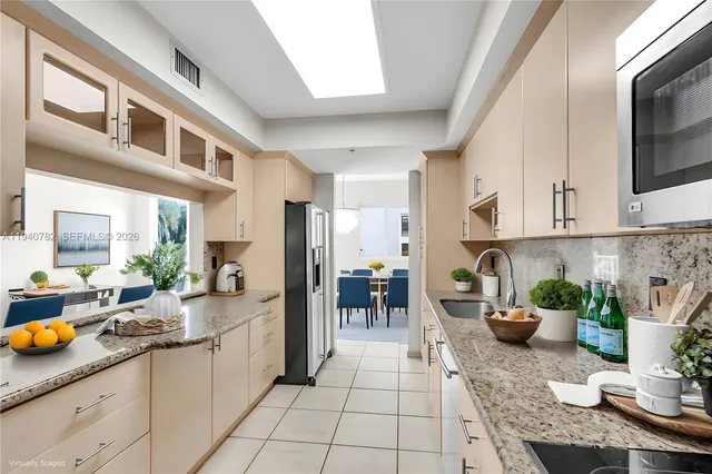a kitchen with white cabinets and appliances