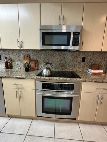 a view of a dining room with a table and chairs